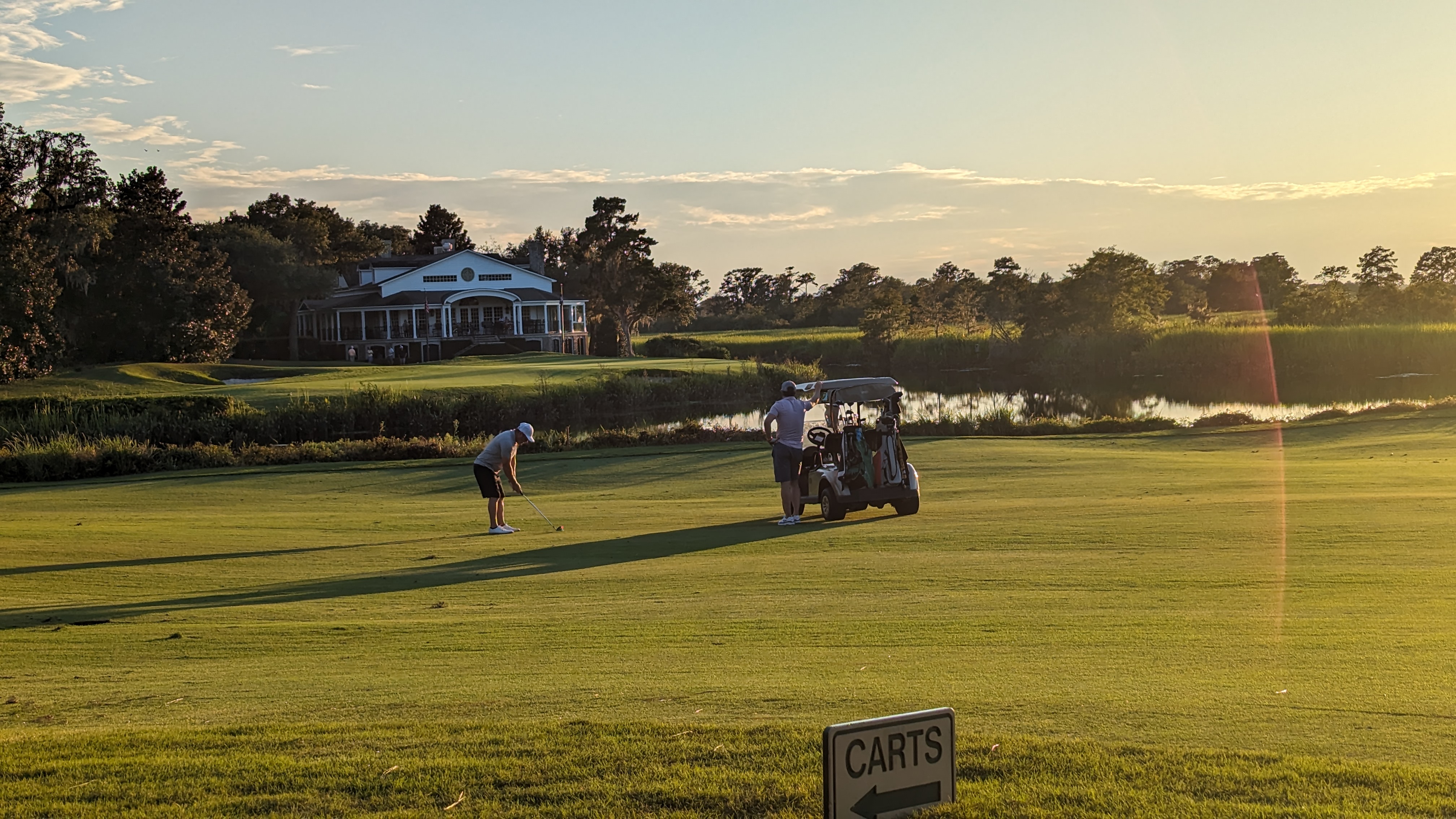 Golfer putting at golden hour